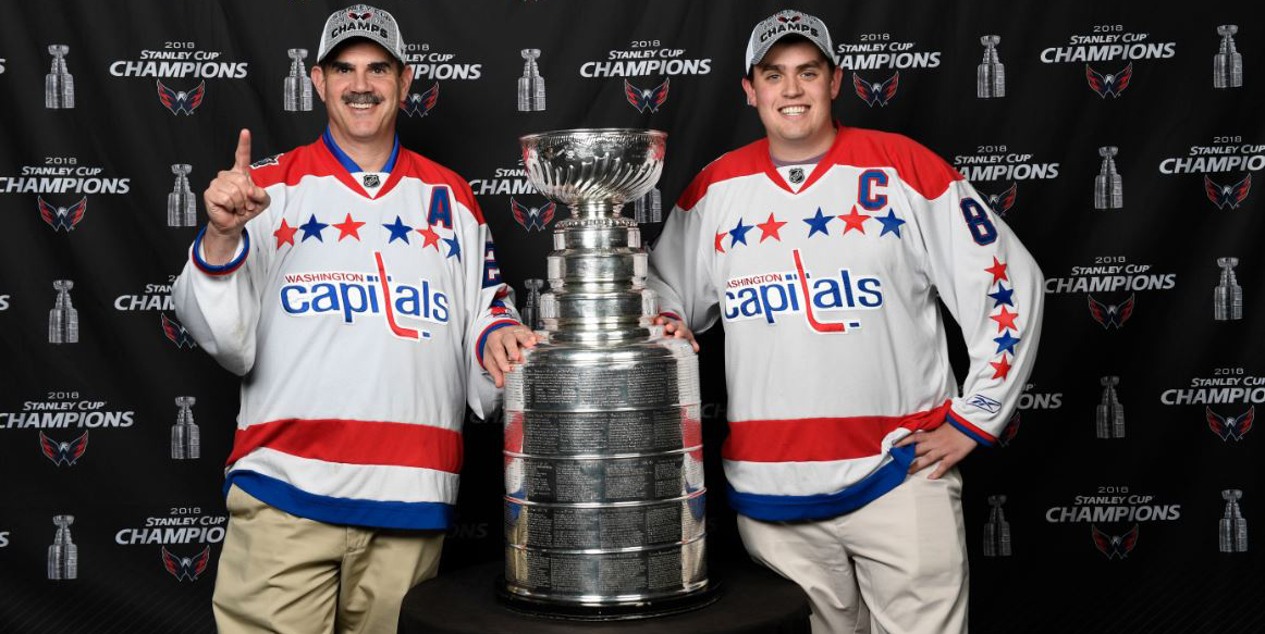 Don Featherstone, a hockey player, hockey coach, and avid Capitals fan, pictured with his son and the Stanley Cup.