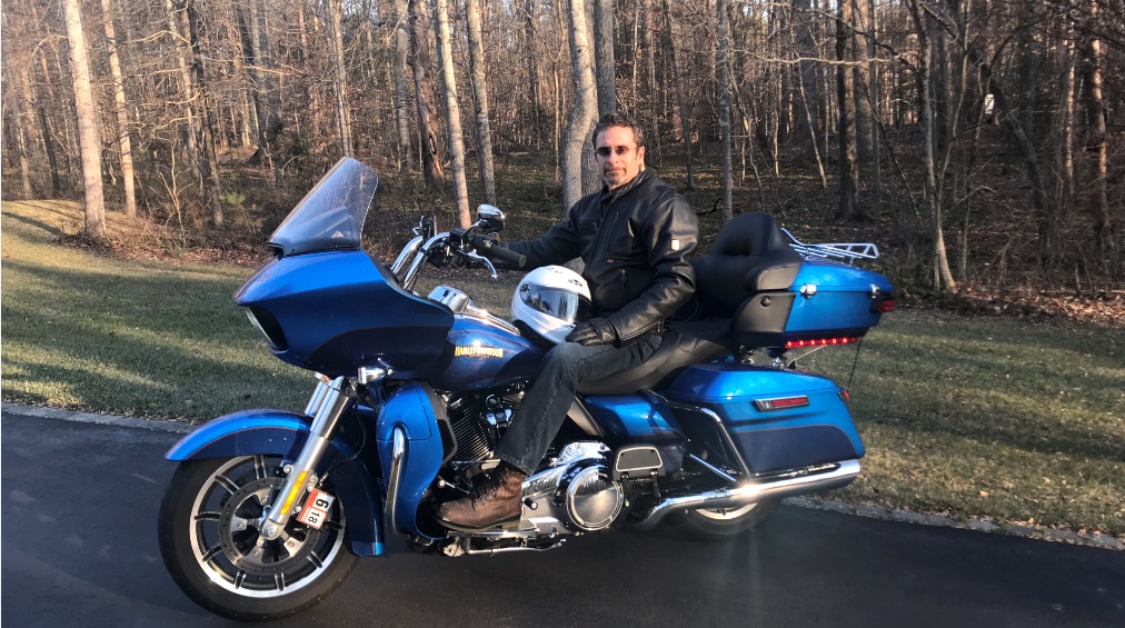 Mike is pictured on his impressive blue motorcycle.